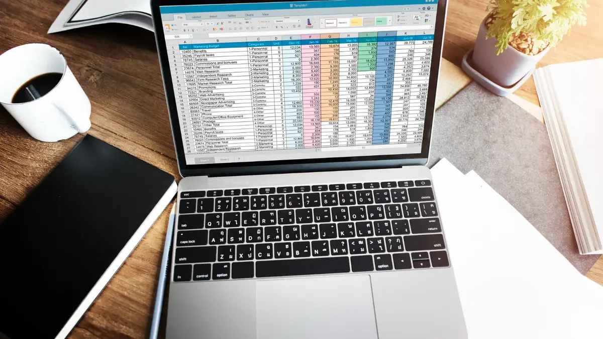 Spreadsheet on a laptop used to map WooCommerce URLs to Shopify URLs